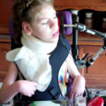 White female student pushing a switch